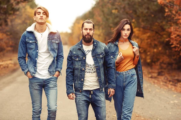 Stylish young company, wearing casual jeans and jacket standing