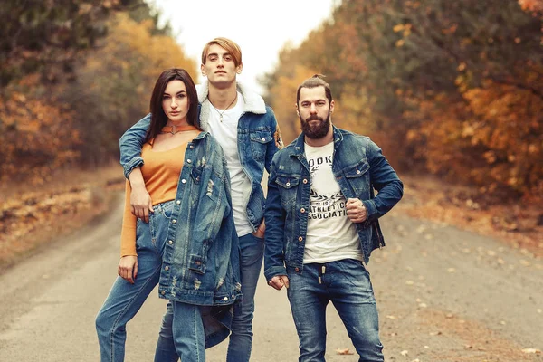 Stylish young company, wearing casual jeans and jacket standing
