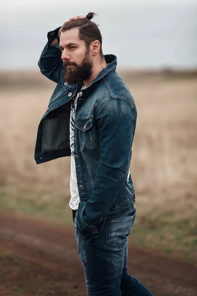 Bonito jovem barba em jeans casual desgaste andando no roa — Fotografia de Stock