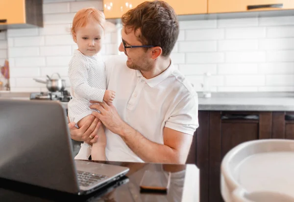 Joven Guapo Trabajando Casa Con Portátil Con Bebé Sus Manos — Foto de Stock