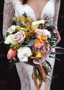 Düğün buketi ellerinde.