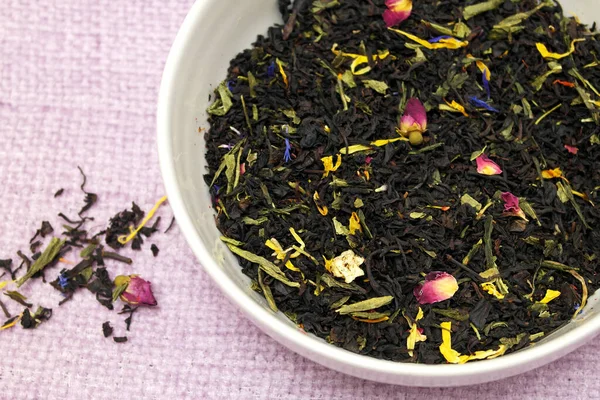 A mixture of black and green leaf tea, with pieces of fruit, rose and cornflower petals, buds and petals of Chinese roses, grapes, apples, from Sri Lanka