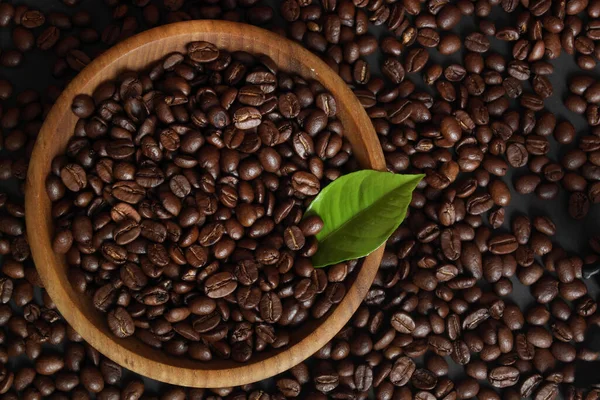 aromatic coffee beans with coffee leaf