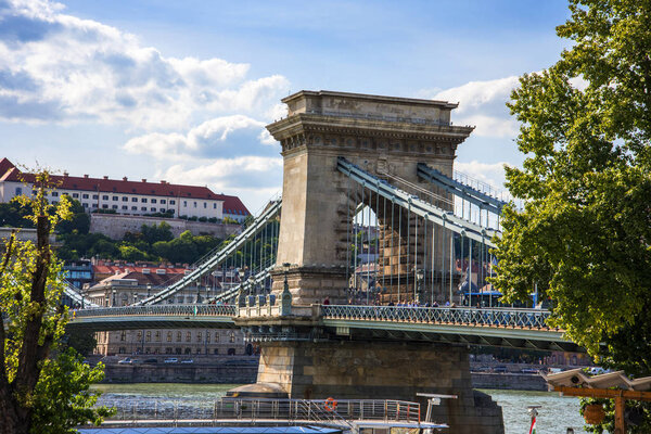 The iconic Chain Bridge in Budapest Hungary that carries traffic across the River Danube in the Baroque city of Budapest.. Designed by English Engineer William Tierney Clark was the first across the Danube and was opened to traffic in 1849