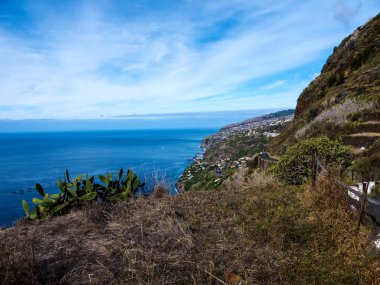 Madeira is a very mountainous Island with steep cliffs falling into the Atlantic Ocean.Mists roll over and through the Mountains.The roads are steep and tortuous with many tunnels Everywhere there are flowers and terraces or levadas growing crops
