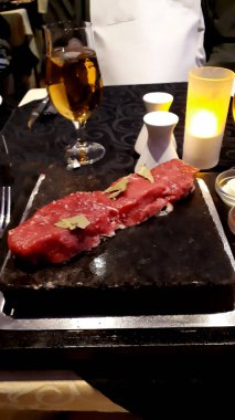 Madeira Adası 'ndaki Funchal' da sevdiğin gibi masada biftek pişiyor. Taş volkanik kayadır. Isıtılır ve özel bir konteynırın içindedir. Böylece ne kadar pişmesini tercih edeceğini kontrol edebilirsin.