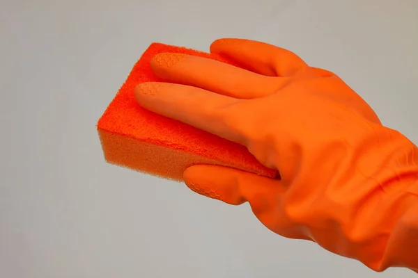 Orange Glove Cleaning Orange Wisp Grey Background Copy Space — Stock Photo, Image