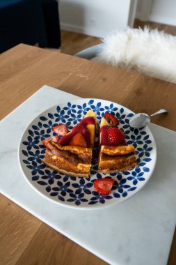 Renkli tabakta taze çilek ve çilek soslu cheesecake. Tatlı nefis..