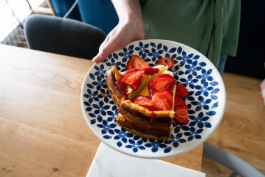 Renkli tabakta taze çilek ve çilek soslu cheesecake. Tatlı nefis..