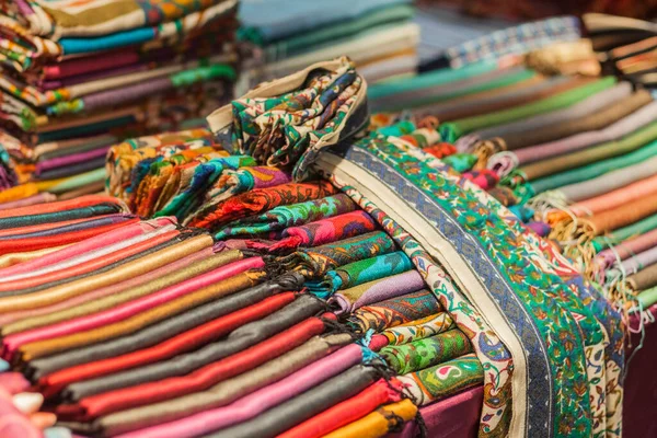 Colorful fabrics on a counter, at a Turkish bazaar