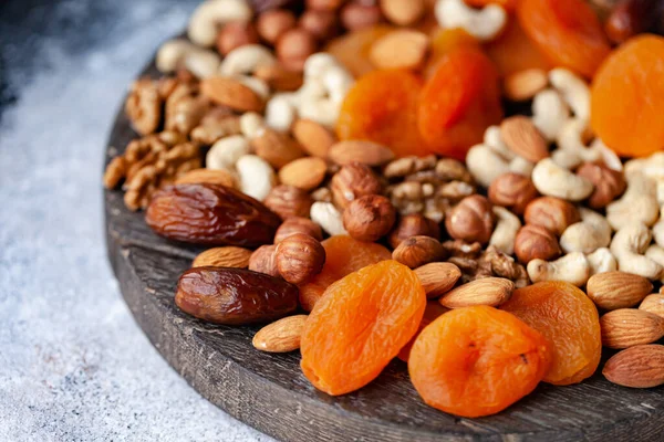 Natural healthy and delicious vegan dessert. Concept of sweet, low calories and tasty snack. Dry fruits and spices. Wooden dark rustic board, neutral background. Close up, macro