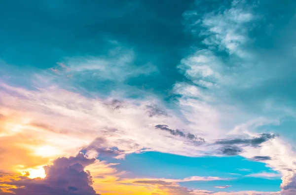 Orange sun light and purple clouds in blue green sky