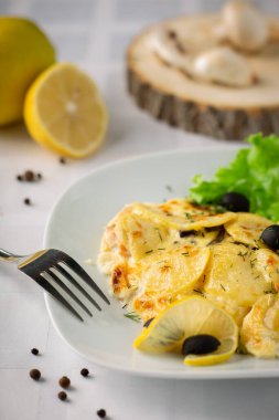 Tahtada patates, peynir, limon ve mantarlı sıcak yemek.