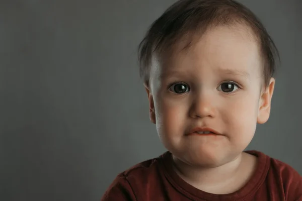 Portrait Scared Little Boy Bitten Lip Gray Background — Stock Photo, Image