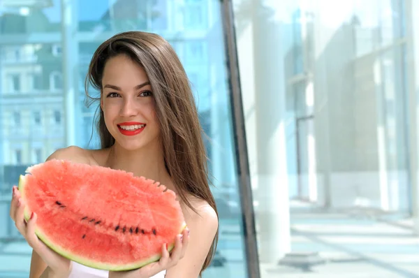 Girl holds red watermelon with two hands — Stock Photo, Image