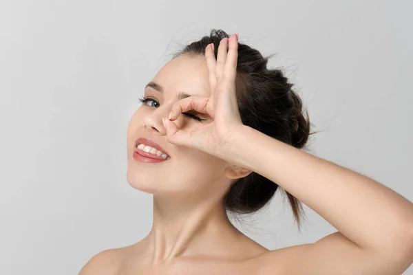 Girl shows a sign all ok and smiles — Stock Photo, Image