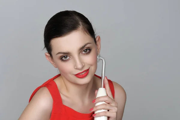 Beautiful girl does darsonvalization on her face — Stock Photo, Image