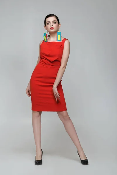 Mooi meisje in een rode jurk in volle groei — Stockfoto