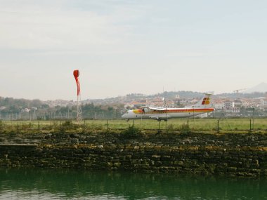 Iberia Airplane Landing at San Sebastian Airport clipart