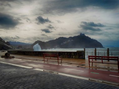 San Sebastian awesome Seafront with Waves and Clouds in Winter clipart