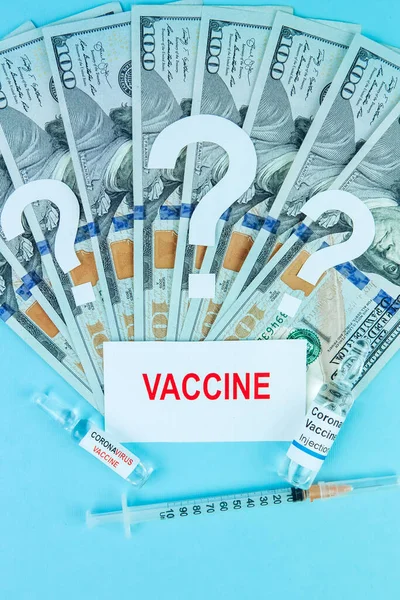 the cost of a coronavirus vaccine. vaccine ampoule on a hundred dollar bill. text. Place for text. the world is waiting for a cure for covid-19. Medicines business