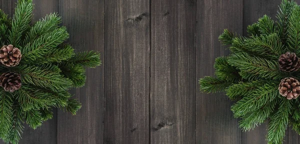 Christmas fir tree branches and pine on dark rustic wooden backg — Stock Photo, Image