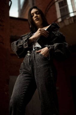 Duvara dayanmış bir kız, alt manzara.