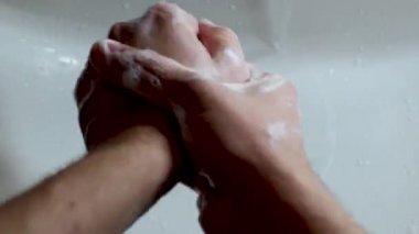 COVID-19 salgını önleme sabunla ellerini yıka. Parmaklarımı ovuyorum. Erkek el yıkama.
