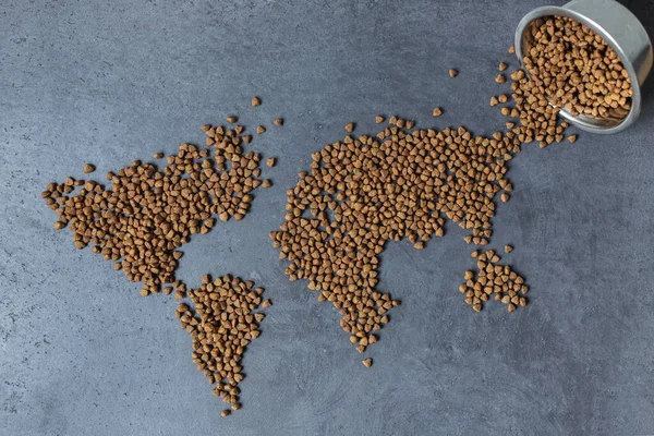 A map of the world that is laid out from dog food. Flat lay of world map. Top view.