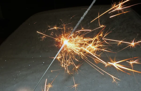 Bright festive Christmas sparkler in hand toning — Stock Photo, Image