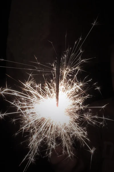 Bright festive Christmas sparkler in hand toning — Stock Photo, Image