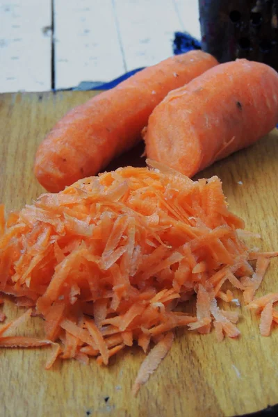 Carrots grated on a grater — Stock Photo, Image