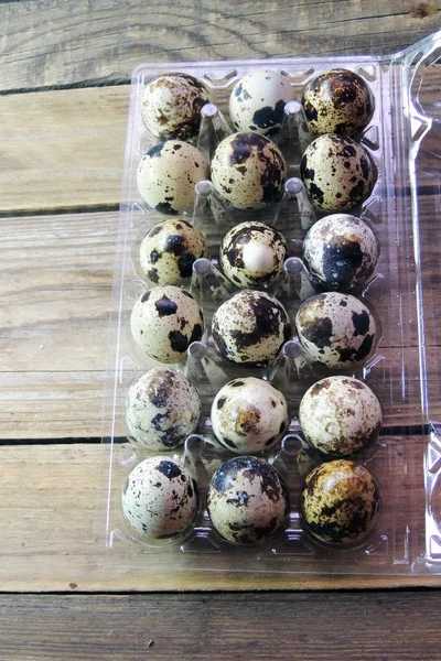 Quail eggs wheat on wooden table — Stock Photo, Image