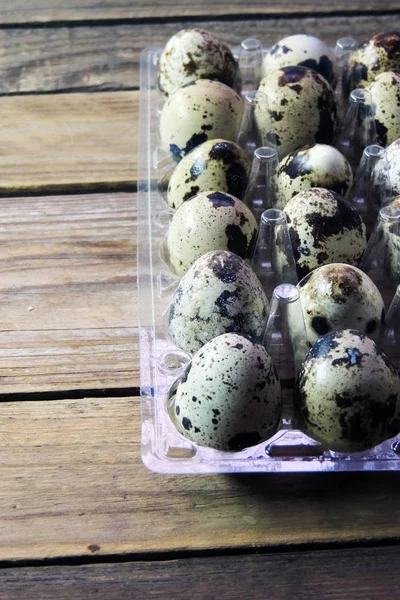 Quail eggs wheat on wooden table — Stock Photo, Image