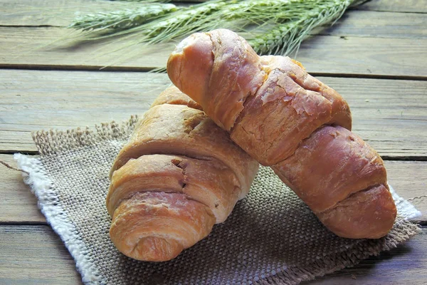 stock image Croissant and spikelets of wheat