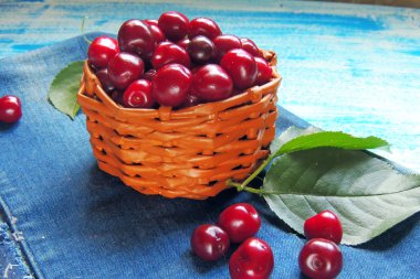 Olgun Kiraz sepeti yaz yeşillik güneş ışığı altında karşı kırsal üzerinde eski ahşap tablo 