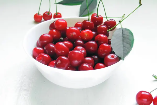 Cerezas maduras en cesta sobre mesa de madera vieja — Foto de Stock