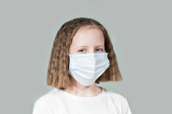 a teenage girl in a disposable mask