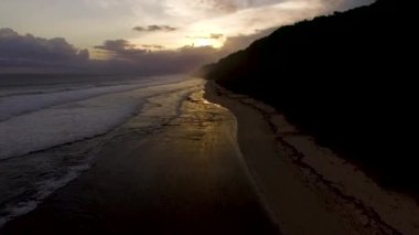 Okyanus dalgaları sahile önce sunset bulvarında kırma hava dron görüntüleri. Bali, Endonezya