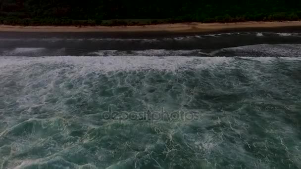 Aerial drone footage of ocean waves breaking before the shore on sunset. Bali, Indonesia — Stock Video