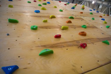 Full frame shot of the artificial climbing wall in the fitness club's brightest studs clipart