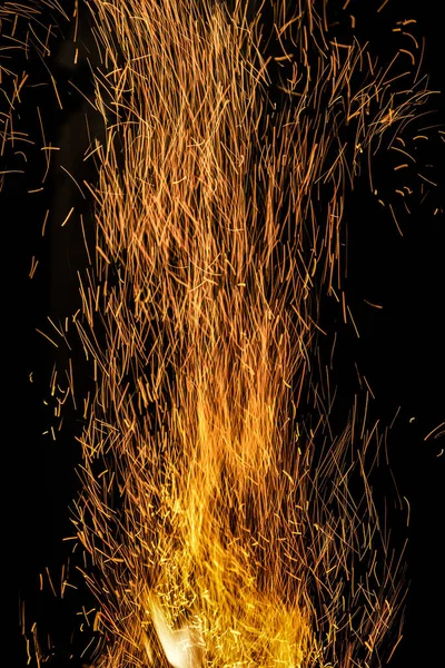 Many bright orange burning sparks rise up — 스톡 사진