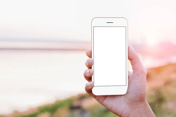 close-up hand holding phone mobile showing screen at outdoor dur