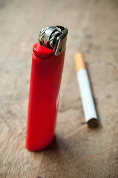 Red lighter and cigarette — Stock Photo, Image