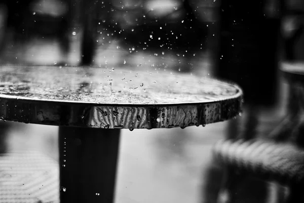 rain falling on a restaurant table in outdoor