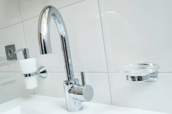 Sanitaire avec robinet en chrome et salle de bain blanche — Photo