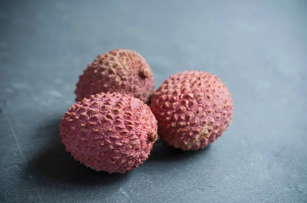Group of lychees on chalkboard background — Stock Photo, Image