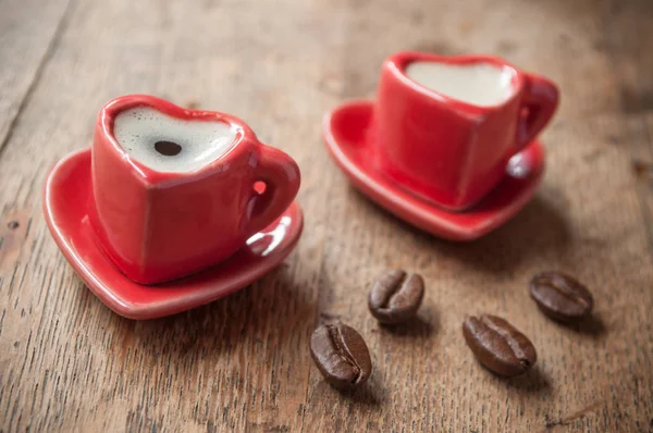 Shaping heart cup of coffee with coffee beans — Stock Photo, Image