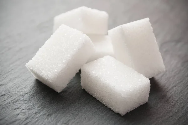 Sugar cube on chalkboard background — Stock Photo, Image