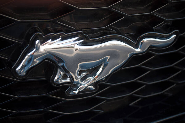  closeup of ford mustang logo on car